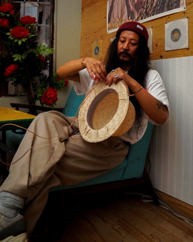 Shoko Yokoyama hand-stitching a straw hat in the Yokkoyama Hat Market shop